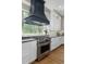 Modern kitchen with stainless steel appliances, white cabinets, granite countertops, and hardwood flooring at 78 Cuthbert Ln Ne, Acworth, GA 30101