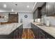 Modern basement kitchenette featuring marble countertops, custom cabinets, and a stainless steel faucet at 78 Cuthbert Ln Ne, Acworth, GA 30101