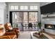 Open living room with a fireplace and sliding glass doors leading to a covered porch with outdoor dining set at 78 Cuthbert Ln Ne, Acworth, GA 30101
