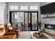 Open living room with a fireplace and sliding glass doors leading to a covered porch with outdoor dining set at 78 Cuthbert Ln Ne, Acworth, GA 30101
