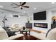 Modern living room with a sleek fireplace, large TV, and comfortable seating area with recessed lighting at 78 Cuthbert Ln Ne, Acworth, GA 30101