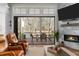 Open living room with a fireplace and sliding glass doors leading to a covered porch with outdoor dining set at 78 Cuthbert Ln Ne, Acworth, GA 30101