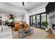 Spacious open-concept living room with modern furniture, a stone fireplace, and an adjacent kitchen at 78 Cuthbert Ln Ne, Acworth, GA 30101