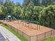 Community playground with swings, slides, and picnic tables bordered with woodchips and a black fence at 78 Cuthbert Ln Ne, Acworth, GA 30101