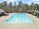 Large community pool with mature trees surrounding and poolside tables and chairs at 78 Cuthbert Ln Ne, Acworth, GA 30101