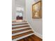 Elegant staircase with hardwood treads leads to a bright office space with an artistic wall painting at 78 Cuthbert Ln Ne, Acworth, GA 30101