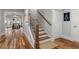 Warm and inviting staircase with hardwood floors and iron railings leads to the dining and living area at 78 Cuthbert Ln Ne, Acworth, GA 30101