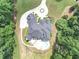 A beautiful home with a large pool, circular driveway, and lush landscaping shown from above at 4233 Sandstone Shores Dr, Stonecrest, GA 30038