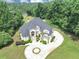 An aerial view captures the elegant exterior, circular drive, landscaping and private backyard of this grand estate at 4233 Sandstone Shores Dr, Stonecrest, GA 30038