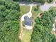 Aerial view of the property with a circular driveway and a large backyard pool at 4233 Sandstone Shores Dr, Stonecrest, GA 30038