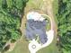 An aerial view showcasing a large home with a pool, circular driveway, and lush landscaping at 4233 Sandstone Shores Dr, Stonecrest, GA 30038