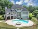 Aerial view of the back of the house with a swimming pool, spa, deck and large yard at 4233 Sandstone Shores Dr, Stonecrest, GA 30038