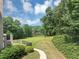 Lush backyard with a pathway leading to a serene pond at 4233 Sandstone Shores Dr, Stonecrest, GA 30038