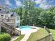 Back exterior view with a pool and deck at 4233 Sandstone Shores Dr, Stonecrest, GA 30038