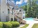 Back exterior view with a pool and deck at 4233 Sandstone Shores Dr, Stonecrest, GA 30038