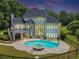Back exterior view with a pool and deck at 4233 Sandstone Shores Dr, Stonecrest, GA 30038