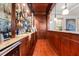 Elegant bar area with wood cabinetry, glass shelving, and ample storage at 4233 Sandstone Shores Dr, Stonecrest, GA 30038