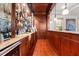 Elaborate home bar featuring ample storage, granite countertop, wine fridge and glass shelving at 4233 Sandstone Shores Dr, Stonecrest, GA 30038