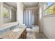 Well-lit bathroom featuring a granite countertop, tiled shower, and neutral color palette at 4233 Sandstone Shores Dr, Stonecrest, GA 30038
