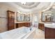 Luxurious bathroom with a large soaking tub, double vanities, and elegant fixtures at 4233 Sandstone Shores Dr, Stonecrest, GA 30038