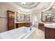 Luxurious bathroom with a soaking tub, dual vanities, and decorative wallpaper at 4233 Sandstone Shores Dr, Stonecrest, GA 30038