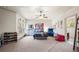 Spacious bedroom with a ceiling fan, large windows, and neutral carpet flooring at 4233 Sandstone Shores Dr, Stonecrest, GA 30038