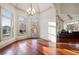 Elegant dining area featuring hardwood floors, chandelier, and large windows with views of the outdoor scenery at 4233 Sandstone Shores Dr, Stonecrest, GA 30038