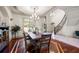 An inviting dining room with an elegant chandelier, millwork, and adjacent staircase for sophisticated gatherings and fine dining at 4233 Sandstone Shores Dr, Stonecrest, GA 30038