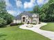 Stunning two-story home with a circular driveway and lush landscaping at 4233 Sandstone Shores Dr, Stonecrest, GA 30038
