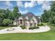 Elegant home with a grand entrance and meticulously maintained front lawn at 4233 Sandstone Shores Dr, Stonecrest, GA 30038