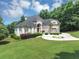 Manicured lawn and circular drive create an inviting approach to this stately home at 4233 Sandstone Shores Dr, Stonecrest, GA 30038