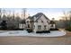 Elegant two-story home with a circular driveway, manicured landscaping, and a stone facade at 4233 Sandstone Shores Dr, Stonecrest, GA 30038