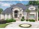 Elegant home featuring a grand entrance, well-manicured landscaping, and circular driveway at 4233 Sandstone Shores Dr, Stonecrest, GA 30038