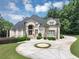 Luxury home featuring meticulous landscaping and an expansive driveway creates an impressive curb appeal at 4233 Sandstone Shores Dr, Stonecrest, GA 30038