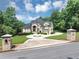 Impressive home featuring a circular driveway, lush lawn, and gated entrance at 4233 Sandstone Shores Dr, Stonecrest, GA 30038