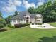 Elegant home with a large circular driveway and meticulously landscaped grounds at 4233 Sandstone Shores Dr, Stonecrest, GA 30038