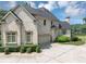 Side view of a brick home featuring an attached garage and well-manicured hedges at 4233 Sandstone Shores Dr, Stonecrest, GA 30038