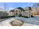 Expansive circular driveway highlighting the home's grand entrance and meticulous landscaping at 4233 Sandstone Shores Dr, Stonecrest, GA 30038