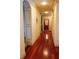 A bright hallway features gorgeous hardwood floors and archway details leading to an elevator at 4233 Sandstone Shores Dr, Stonecrest, GA 30038