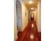 Long hallway with wood floors, decorative trim, and neutral walls that create a welcoming and bright passage at 4233 Sandstone Shores Dr, Stonecrest, GA 30038