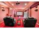 Comfortable home theater with reclining chairs, a projector, and a large screen at 4233 Sandstone Shores Dr, Stonecrest, GA 30038