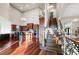 Open-concept living space with kitchen, breakfast bar, and staircase, illuminated by high ceilings and natural light at 4233 Sandstone Shores Dr, Stonecrest, GA 30038