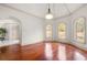 Bright living room with hardwood floors, arched windows, and elegant trim at 4233 Sandstone Shores Dr, Stonecrest, GA 30038