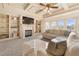 Cozy living room with a fireplace, built-in shelves, and large windows providing ample natural light at 4233 Sandstone Shores Dr, Stonecrest, GA 30038