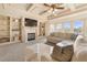 Bright living room with fireplace, built-in shelving, coffered ceiling, and large windows offering ample natural light at 4233 Sandstone Shores Dr, Stonecrest, GA 30038