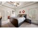 Serene main bedroom with a tray ceiling, plush carpet, and ample natural light at 4233 Sandstone Shores Dr, Stonecrest, GA 30038