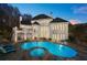 Backyard oasis featuring a large swimming pool, hot tub, and spacious patio at 4233 Sandstone Shores Dr, Stonecrest, GA 30038