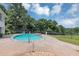 A backyard pool with a spa, surrounded by a concrete deck and a black metal fence at 4233 Sandstone Shores Dr, Stonecrest, GA 30038