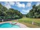 Relaxing backyard pool and spa overlooks a serene lake view, perfect for outdoor enjoyment at 4233 Sandstone Shores Dr, Stonecrest, GA 30038