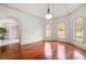 Bright and airy room with hardwood floors, arched doorways, and large windows at 4233 Sandstone Shores Dr, Stonecrest, GA 30038